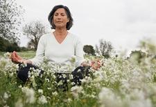 Woman meditating in a field 
