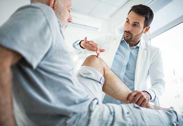 Provider examining a patient's knee.